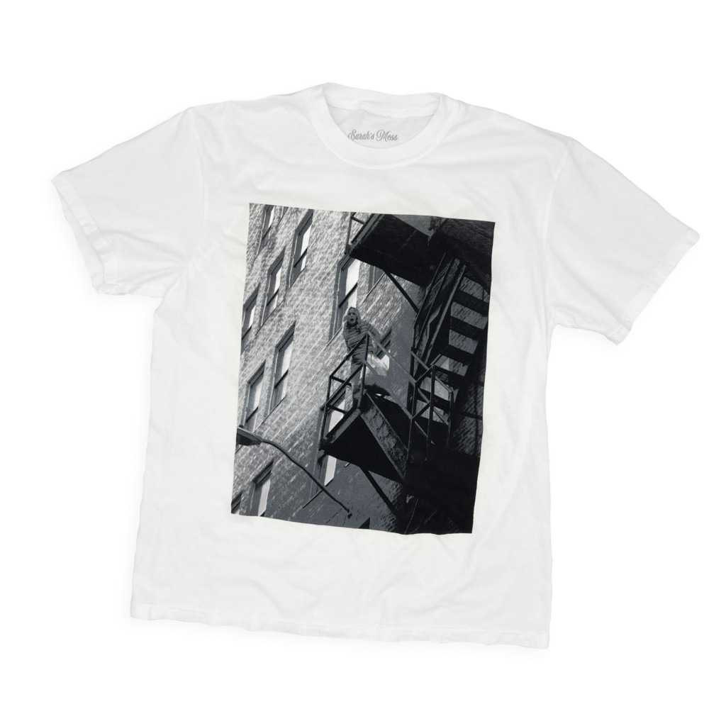 Studio-style shot of the Scream Tee on a transparent background, featuring a large black-and-white print of Jeana Mahan’s face from the movie.